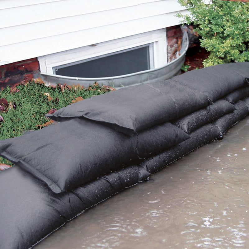 Quick Dam Flood Bags 12" x 24" x 3" Sandless Sandbags  next to a house